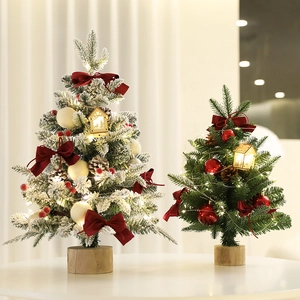 Mini tabletop Christmas trees with snow flocking, red bows, pine cones and LED lights