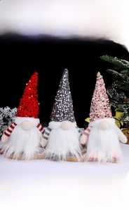 Detailed close-up of three festive Christmas gnomes with sequins and white plush beards