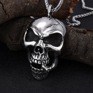 Detailed close-up of a men's stainless steel skull pendant with cigar on a thick chain