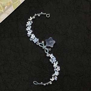 Handmade light blue pearl bracelet with flower, star charms and woven cord chain