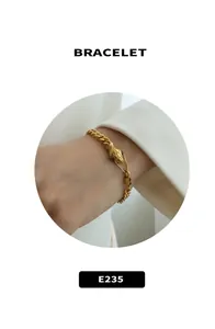 Detail of golden snake-head bracelet with scale texture and sleek snake bone chain link