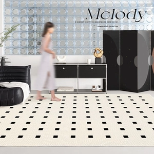 Detail of French minimalist PVC door mat with black checkered dot pattern on beige surface