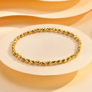 Macro view of gold faceted hematite beads on a minimalist stackable bracelet design
