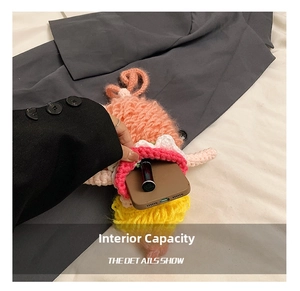 Detail showing the internal storage capacity of the handmade crochet crossbody child bag
