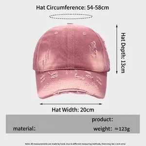 Pink distressed cotton baseball cap with ripped details and size chart specifications
