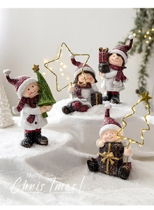 Set of four resin Christmas figurines with matte snow texture on festive background