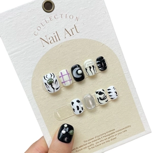 Handmade press-on nail set featuring black and white hand-drawn anime and pattern designs