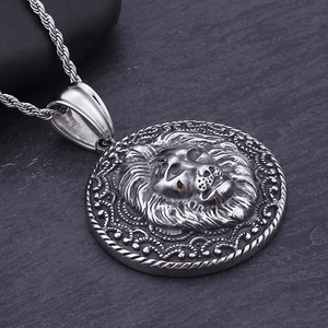 Close-up of vintage lion head pendant in antique silver with twisted rope chain
