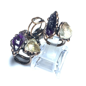 Detailed macro shot of vintage handmade rings with natural amethyst and citrine stones