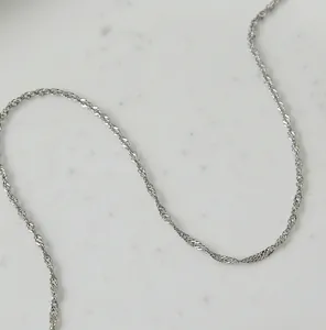 Detailed close-up showing the twisted structure of a silver water wave chain necklace