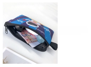 Internal view of the blue astronaut canvas coin purse showing storage capacity with zipper