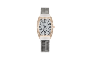 Detail of rose gold tonneau watch with crystal bezel and silver milanese mesh strap