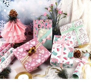 Detail of assorted wrapping paper rolls featuring heart, cactus, and fruit patterns