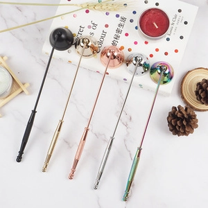 Detailed set of five metallic bell-shaped candle snuffers in varied finishes on marble