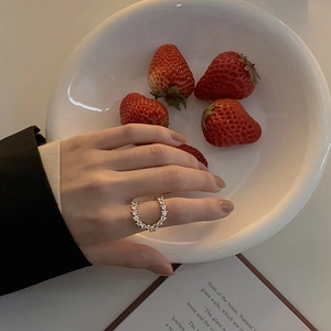 Detailed close-up of a luxury gold ring with diamonds on a model hand with ins style vibes