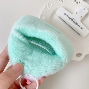 Detail view of mint green plush card holder showing soft faux fur texture and mesh lining