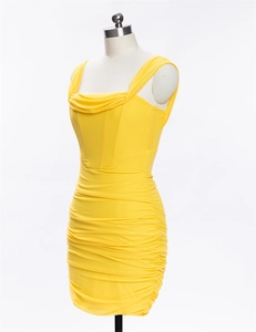 Detail of yellow mini dress featuring a cowl neckline and elegant ruched fabric textures