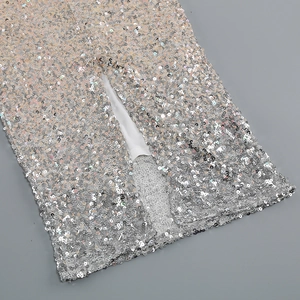 Detail of silver sequin dress showing high slit design and premium sewing craftsmanship