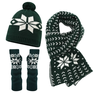 Three-piece winter knit set with green snowflake pattern hat scarf and gloves