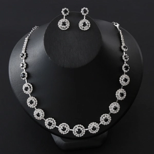Elegant silver necklace and earrings set with black round stones and clear crystals