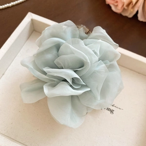 Nahaufnahme einer großen hellblauen Chiffon-Blume Haarspange auf einem weißen Tablett