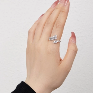 Close-up of sparkling S925 sterling silver snake ring with pavé zircons on model's finger