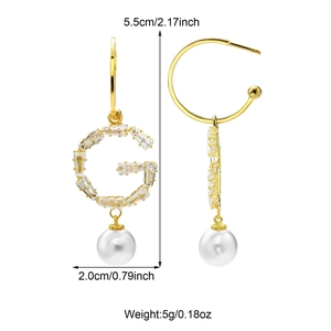 Detailed view of copper bowknot earrings with G-letter, pearl drops, and dimensions