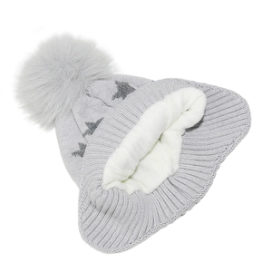 Detail of shark knitted hat with soft fleece lining and fluffy faux fur pom-pom decor