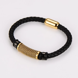Detail of black braided leather bracelet with golden magnetic clasp and mesh metal tube
