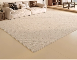 Detailed macro view of beige woven carpet texture with durable stitched edges in a living room