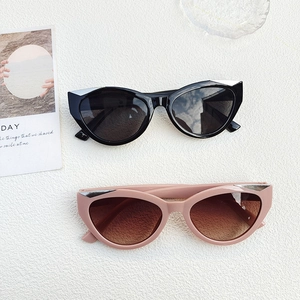 Stylish cat-eye sunglasses in black and pink frames with silver accents for Y2K fashion