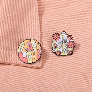 Set of 2 Peace Love enamel pins featuring vintage floral peace signs on pink fabric