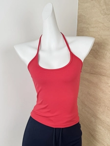 Detailed view of red halter neck slim fit top on mannequin with ribbed texture