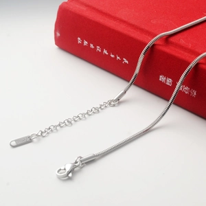 Detail of stainless steel snake chain with S.STEEL stamp, lobster clasp and extension