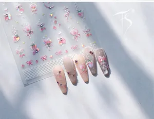 Detail of 3D embossed strawberry and pink bow nail art stickers with glossy glitter finish