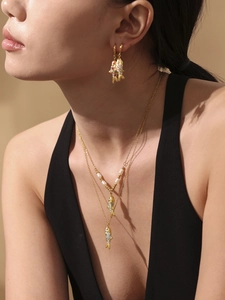 Model wearing gold koi fish jewelry set featuring enamel pendant and pearl double layer necklace
