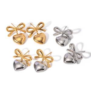 Contrast heart drop earrings with bow accents in gold, silver and mixed metal finishes