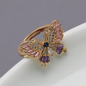 Minimalist butterfly open ring with colorful zircon stones on white ceramic edge