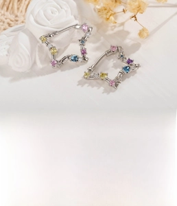 Detailed view of silver star hoop earrings with colorful zircons and 10mm inner diameter