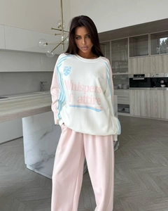 Detail of pink and white oversized sweatshirt set with vintage chest print and loose fit