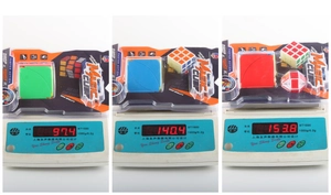 Detailed comparison of three Magic Cube sets on digital scales showing weight in grams