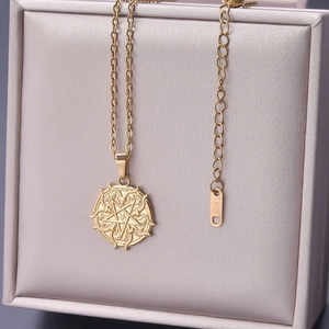 Close-up of golden stainless steel pentagram pendant showing the S. STEEL logo tag
