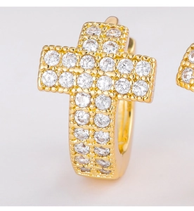 Macro view of gold plated cross hoop earrings with sparkling cubic zirconia inlay