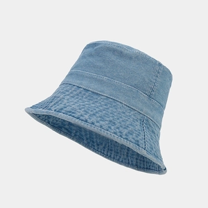 Detailed close-up of light blue denim bucket hat showing fabric texture and stitched brim