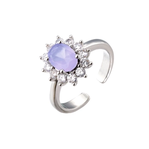 Oval purple zircon ring with a floral halo of clear stones on an adjustable silver band
