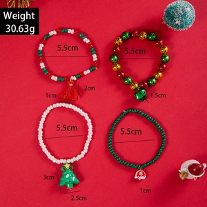 Christmas themed beaded bracelet set with Santa Claus and reindeer charms on red background