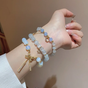 Three-piece beaded bracelet set with cat eye stones and gold butterfly star moon charms