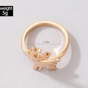 Close-up of rose gold reindeer ring featuring holiday enamel details and size measurements