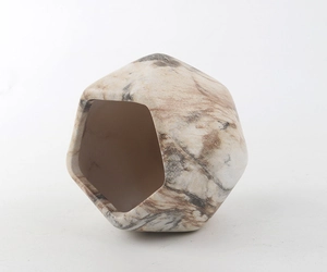 Detail of geometric ceramic planter with marble texture and smooth matte finish