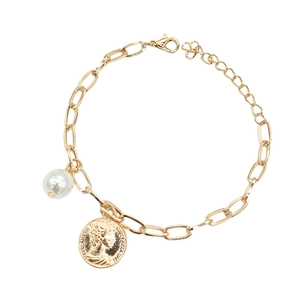 Detail of gold chain bracelet featuring a white pearl and Elizabeth II coin charm pendant